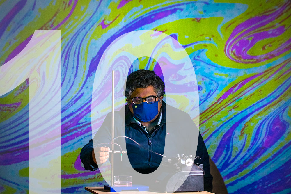 A faculty member in a lab and a superimposed number 